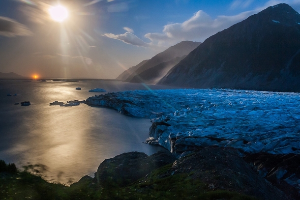 A timelapse camera used to study the movement of Bear Glacier Alaska unexpectedly caught this view of the full moon over its lagoon  Photo by Kenai Fjords National Park