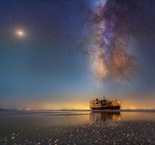 Another wonderful shipThe summer Milky Way is very prominent in this photo On the galaxy zone Saturn is located besides the Lagoon nebula On the right of the horizon you can see the extreme light pollution of Urmia which is caused by ever-increasing city 