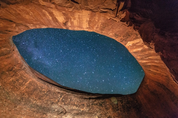 Looking Through the Eye of the Universe in Moab Utah by Ty MacDonald 