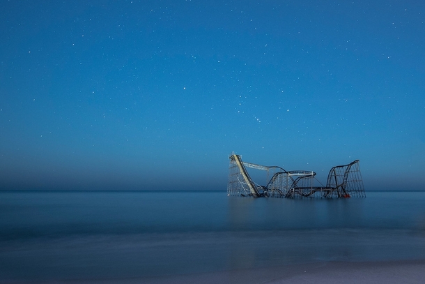 Starry skies over the Jet Star Roller Coaster sitting in the Atlantic Ocean by Jack Fusco 