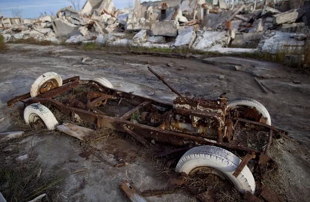 The chassis of a car sits in the mud and silt In a town that was submerged by heavy rains after a nearby dam broke over  years ago Epecuen Argentina 