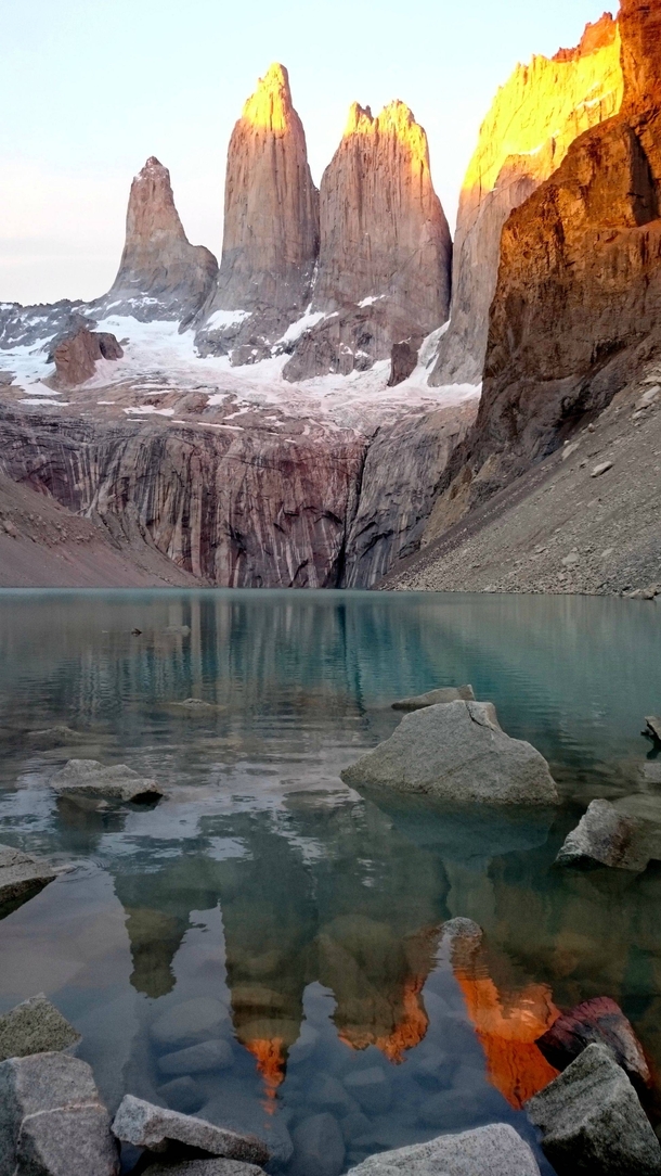 Torres del Paine with reflection over water 
