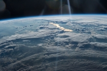  Beams of Light on a Golden Lake seen from the ISS