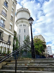  France - Paris The water tower of Montmartre seen from the rue du Mont-Cenis