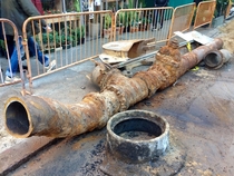  Old water main removed from ground on th street between Avenue A and st avenue in New York City