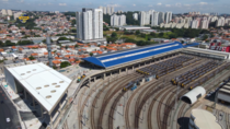 A bus terminal under construction on top of a train yard next to a subway station building on the left Vila Snia Terminal So Paulo Brazil