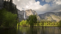 A classic view of Yosemite Falls from Swinging Bridge as late-afternoon thunderstorms develop 