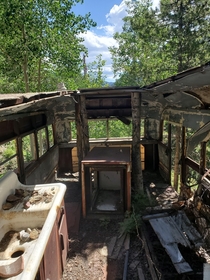 A converted bus into a travel camper found abandoned in the woods of colorado