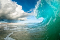 A crashing wave on the beach Photo by Chris Burkard 