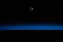A crescent moon and Earths horizon are featured in this nighttime image photographed by an Expedition  crew member on the International Space Station May   