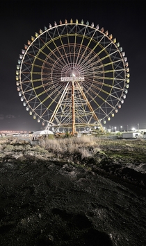 A ferris wheel in an abandoned theme park in Japan  By Reginald Van de Velde
