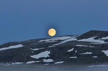 A full moon in the fjords of Norway  oc