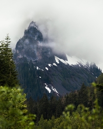 A mountain peaking through the cloudy spring skies of British Columbia 
