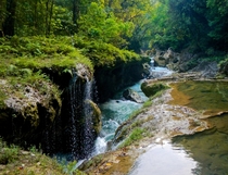 A natural limestone bridge creates a plethora of creeks pools and waterfalls while the mass majority of the Cahabn River rages below Semuc Champey Lanquin Guatemala 