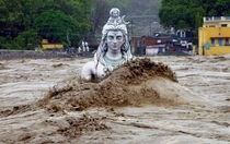 A partially submerged statue of Shiva stands in the flooded River Ganges in Rishikesh in the northern Indian state of Uttarakhand June   