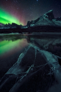 A quiet showing of aurora over a frozen lake Tombstone Territorial Park YT Canada 