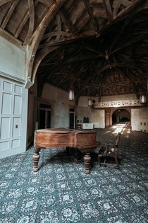 A -room mansion sitting abandoned in New York State this is the piano room during sunset 