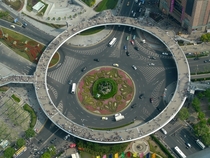 A roundabout in Lujiazui China that has a pedestrian bridge in the form of another raised roundabout 