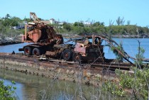 A rusting barge and crane in Hatchet Bay Eleuthera Bahamas 