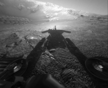 A shadow cast by NASAs Mars Rover Opportunity stretches across the Martian surface in this image from July   NASAAP 