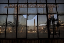 A smokestack is seen through a broken window of a building in the abandoned Qingquan Steel plant  one of several so-called zombie factories in Tangshan China Kevin Frayer 
