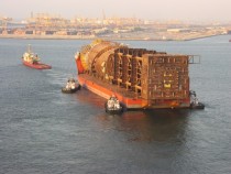 A spar platform being transported by a float onfloat off heavy lift vessel  