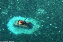 A United States M Sherman tank remains in shallow water off Chalan Kanoa beach in Saipan Northern Mariana Islands 