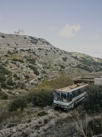 Abandoned bus in Greece watched over by a NATO radar facility