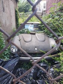 Abandoned Car behind fence