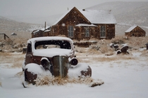 Abandoned car covered with snow at Bodie - ghost town at Mono CA US  photographed by David Goulart