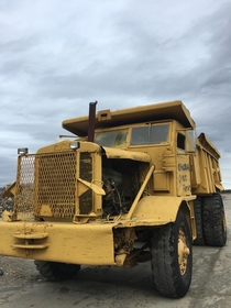 Abandoned dump truck at failed storage complex