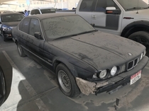 Abandoned E BMW  Series sitting in mall rooftop car park Dubai