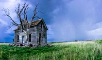Abandoned Farmhouse with rain in the distance WesternCentral Kansas 