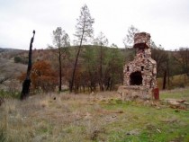 Abandoned fireplace on foundation remains of long-gone cabin just north of Lake Berryessa in Napa CA 