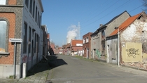 Abandoned street with working Nuclear Plant in background Doel Belgium 