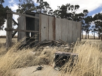Abandoned swimmers changing hut in the middle of a paddock where a once in  year creek forms Rural Australia