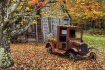 An abandoned home and a  Ford in Maine by Greg Hartford 