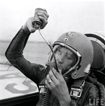 An Air Force test pilot drinking grape juice while wearing an MA- High Altitude Flight Helmet 