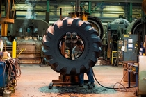 An employee works on the inside of a tire at a tire manufacturing facility in Bryan Ohio 