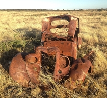 An old car in the grass 