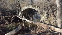 An old keystone bridge located deep in the woods of Talbot conservation area