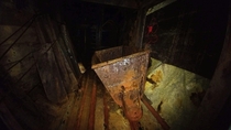 An ore cart and elevator lie abandoned far underground in the abandoned Evening Star Mine Lane County OR OC 