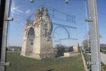 An outline laid over the remains of an ancient structure to show what it would have looked like