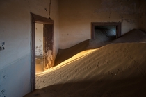 Animal tracks criss-cross sand dunes that have crept into the deserted houses of the ghost town Kolmanskop in Namibia  photo by MrBlackSun