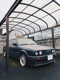 Another abandoned car in Tokyo Japan This ones a classic someone please ID the model thick layer of dust covering the top all  tires flat with BBSsa few magazines scattered in the back seat Beautiful amp timeless