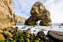 Arched sea stack and rocky beach at Cabo da Roca Portugal 