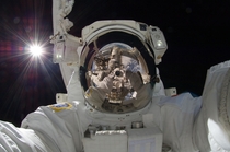 Astronaut Aki Hoshide Expedition  flight engineer uses a digital still camera to expose a photo of his helmet visor during the missions third session of EVA  xpost rtechnologyporn
