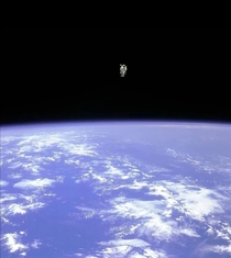 Astronaut Bruce McCandless II as he floated away untethered from the space shuttle with only the manned maneuvering unit keeping him alive  and he was the first person to do so