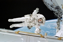 Astronaut Rex J Walheim gives a wave during an EVA during STS- 
