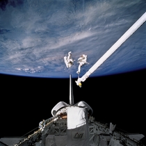 Astronauts Lee and Meade perform an EVA in Discoverys payload bay 